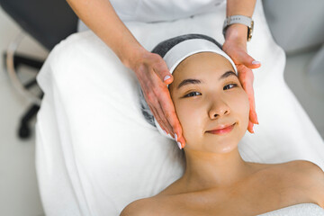 Fototapeta na wymiar Woman getting a face massage by professional massage specialist. High quality photo