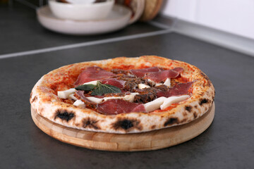 Frozen pizza with beef in the kitchen