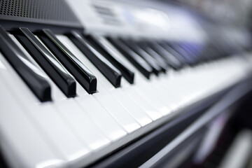 Keys of a synthesizer or grand piano closeup. Monochrome music concept background.