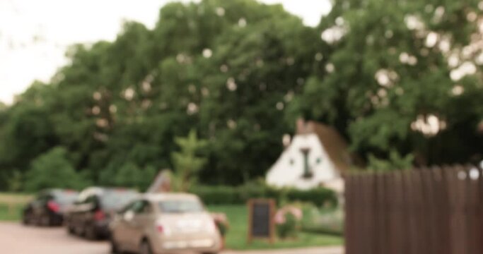 Defocused Blur View Large Parking With Few Cars And Small White House In Background - Defocused Strasbourg