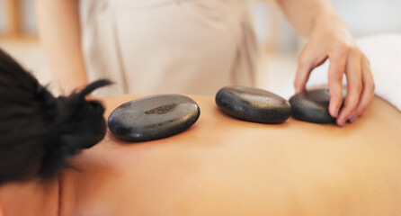Hands, masseuse or hot stone massage in spa, salon or healthcare wellness retreat in self care,...