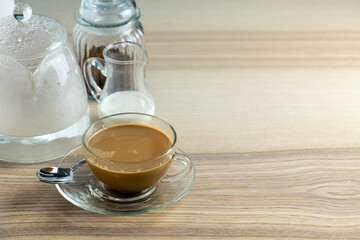 cup of hot Instant coffee dark shot in cup with crema on wooden table and beans . coffee beans and cup full of Intense dark shot coffee in glass cup