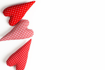 Valentine's Day background. Handmade red hearts on white background. Happy Valentines Day card. Valentines day concept. Flat lay, top view. Copy space