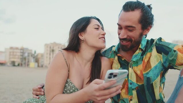 Man and woman looking at photos on mobile phone
