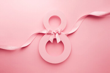 March 8 greeting card. Paper number 8 on a pink background with a ribbon and a bow