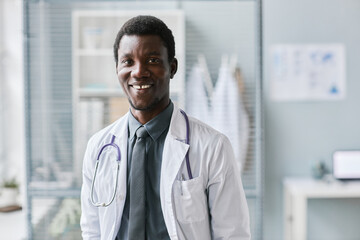 Classic young black doctor smiling at camera with stethoscope