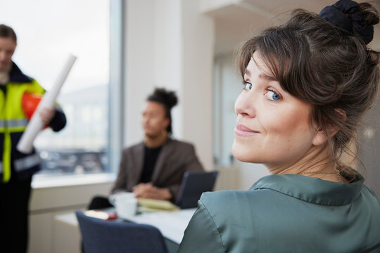 Smiling Woman In Office Looking At Camera