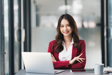 Fototapeta premium Young beautiful businesswoman working on her project in modern office room.