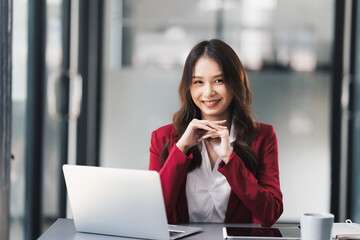 Young beautiful businesswoman working on her project in modern office room.