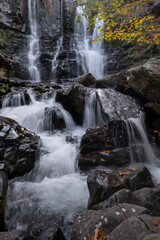 Long exposure of a waterfall in the forest in autum