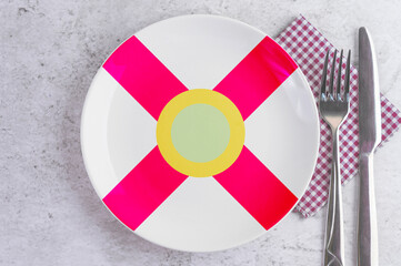 A Plate with the Flag of Florida, Cutlery and Napkins on the Mable Table.