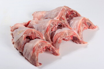 Fresh chicken skeletons on a white background. Raw chicken backs skin on bone. Fresh Chicken Back