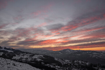 Panorama of a sunset in the italian countryside covered in snow