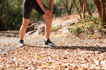 Closeup of feet runner jogging workout stop running, Athlete taking a break during marathon. exercising outdoors workout on forest dirt road. Athlete endurance trail runnin, Sportsman runner.