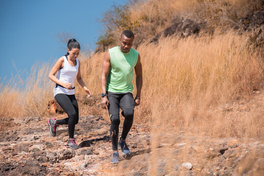 Young Couple Family Or Trainer Running Trail Exercise Outdoor Activities At Mountain In Autumn Season, Happy Woman And Man Wearing Sports Wear Spend Time Together Jogging Or Training In Sunny Day