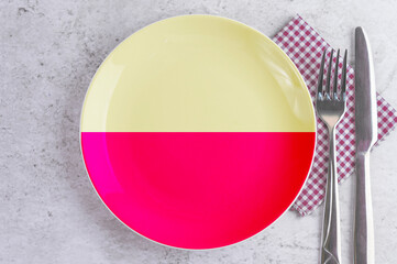 A Plate with the Flag of Karnataka, Cutlery and Napkins on the Mable Table.