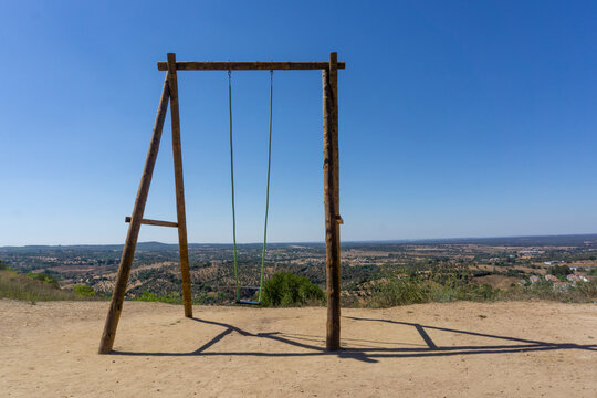 Wooden swing at Montemor-o-Novo, with a beautiful view of mountain, in Portugal
