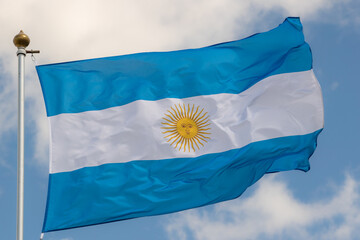 Argentina flag isolated on the blue sky with clipping path. close up waving flag of Argentina. flag symbols of Argentina.