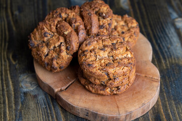 Delicious cookies with pieces of chocolate on the table