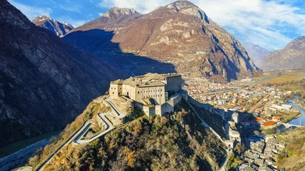 Foto op Canvas Italy .Famous medieval castles of valle d'Aosta - impressive Bard fort surrounded by Alps mountains. aerial drone view © Freesurf