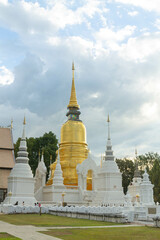 Fototapeta na wymiar Golden and white pagodas in Wat Suan Dok, Chiang Mai