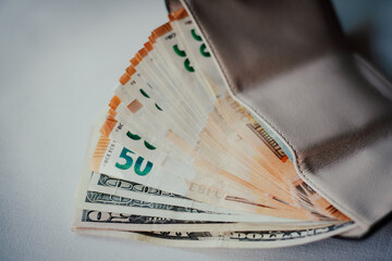 Pay in euros. Get euros from your wallet. Euro bills on a white background with a wallet