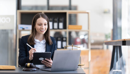 Justice Attorney's Office with Scales and Female Lawyer Working on Laptop, Advice and Justice Lawyer discussing contract documents in the office. legal services real estate ideas advice
