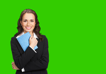 Portrait image of happy smiling business woman black confident suit with notepad organizer. Executive office worker, teacher or real estate agent. Green chroma key background.