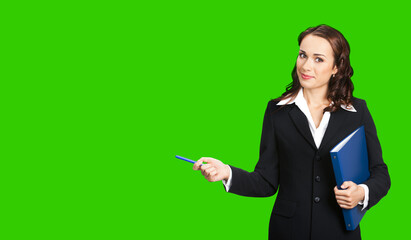 Portrait image of beautiful young business woman in confident suit with folder, showing pointing advertising. Businesswoman, executive worker, teacher gesturing. Green chroma key background.