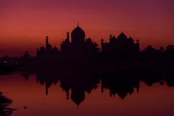 Fototapeta na wymiar Taj Mahal Sunrise Reflection in River with Red Sky, Agra, India