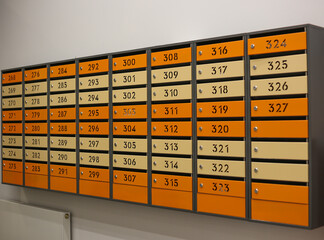 Mailboxes for letters and correspondence. Modern multicolored mailboxes with numbers in the lobby of a residential or office building close-up.