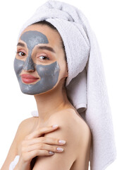 A woman with a gray clay cosmetic mask in a white towel on her head on a white background.