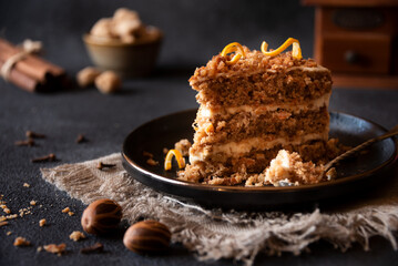 Piece of homemade cake with cinnamon on black plate