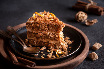 Piece of homemade cake with cinnamon on black plate