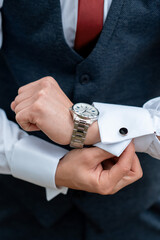 A man checks the time on his wrist watch