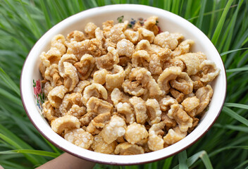 bowl of crispy fried pork skin, food in big bowl, not halal