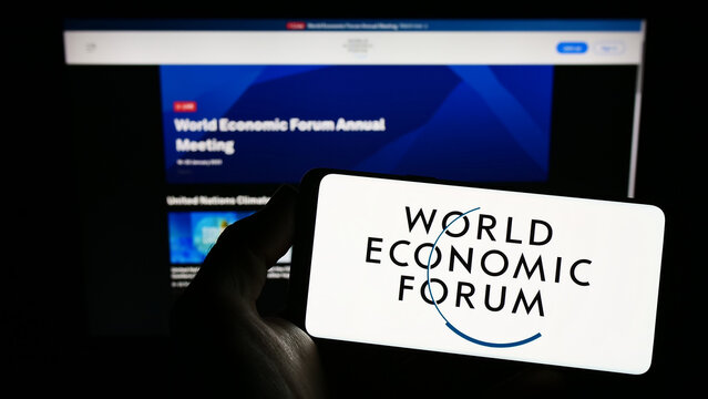 Stuttgart, Germany - 01-21-2023: Person holding smartphone with logo of organisation World Economic Forum (WEF) on screen in front of website. Focus on phone display.