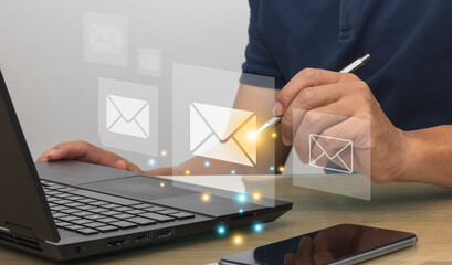 Businessman using laptop with email icon, online communication concept, coordination, online transaction.