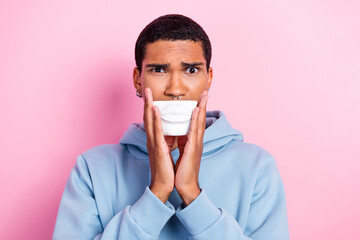 Photo of young student handsome man unhappy want plastic operation surgery hold fake white lips bigger lips isolated over pink color background