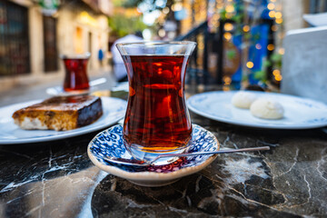 Turkish Tea in traditional tea glass and saucer in Turkey, street travel photo