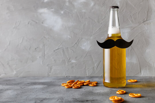 Bottle of beer with moustache. Movember. Concept of father's day, bachelor party.