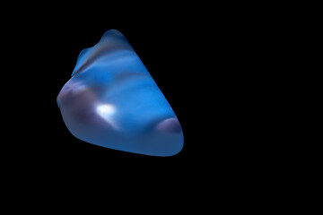Chalcedony mineral illuminated by light.
