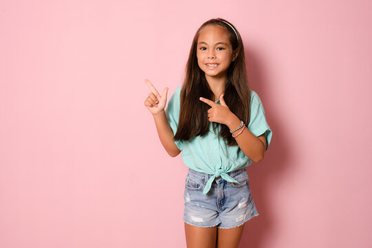 Portrait Of Adorable Kind Sweet Little Girl Impressed Face Expression Promote Offer Isolated On Pink Color Background