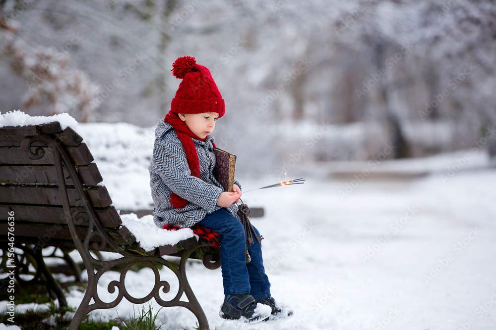 Canvas Prints Beautiful toddler child, cute boy, playing in snowy park winter time