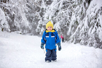Fototapeta na wymiar Sweet happy child, playing in deep snow