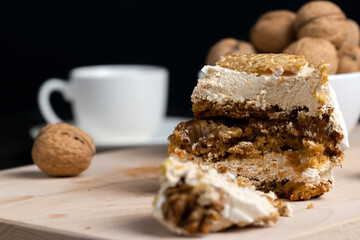 a piece of cake with buttercream and walnuts
