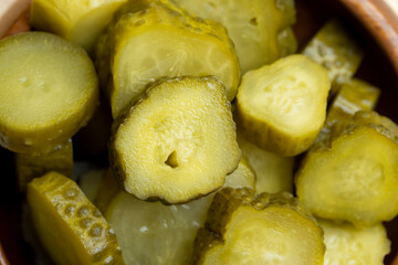 Pickled cucumbers on a wooden table during cooking