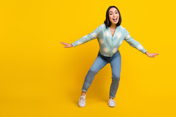 Fototapeta na wymiar Full body cadre photo of satisfied crazy youngster chinese girl dancing chilling meloman cool modern music isolated on yellow color background