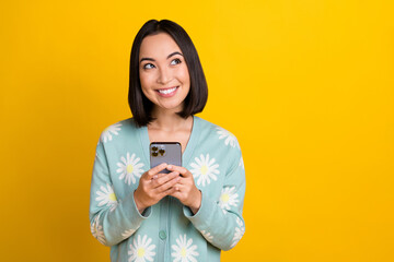 Photo of lovely nice positive woman with bob hairdo dressed blue pullover hold phone look empty...