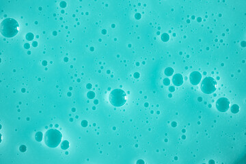 Bubble mint turquoise background texture. Berry gel to cleanse the skin of the face and body. Spa treatments, skin care. Bath foam, detergent. Slime blue